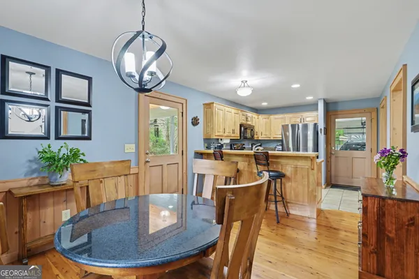 a view of a dining room with furniture a livingroom and chandelier
