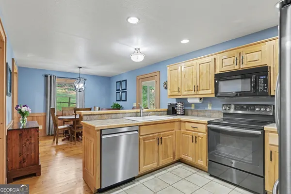 a kitchen with a stove a sink and a microwave