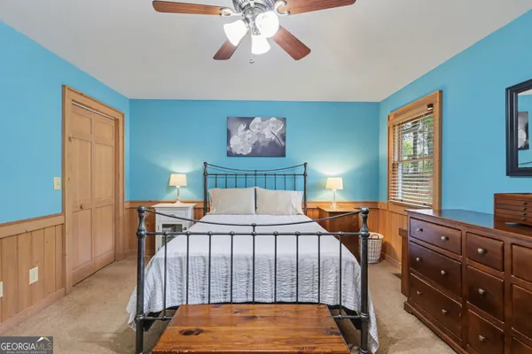 a bedroom with a bed and a chandelier