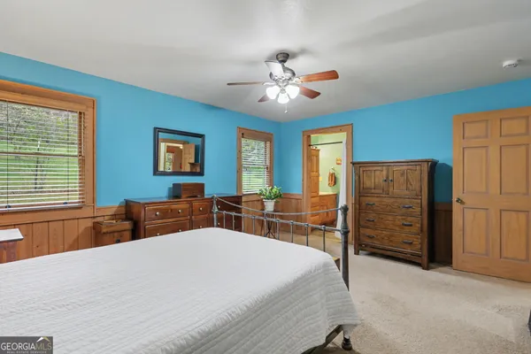 a bedroom with furniture and wooden floor