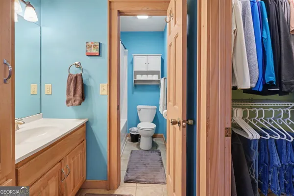 a bathroom with a sink a toilet and shower curtain