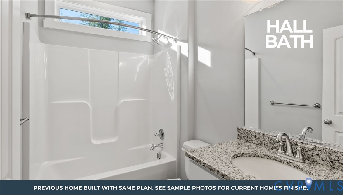 435 Raleigh Avenue South Hill, VA 23970 - Photo 5 of 11 a bathroom with a granite countertop sink a mirror a bathtub and shower