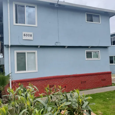 a view of a blue house with a yard