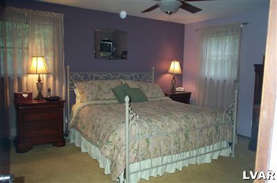 19 Balson Road Stroudsburg, PA 18360 - Photo 8 of 17 a bedroom with a bed and a lamp