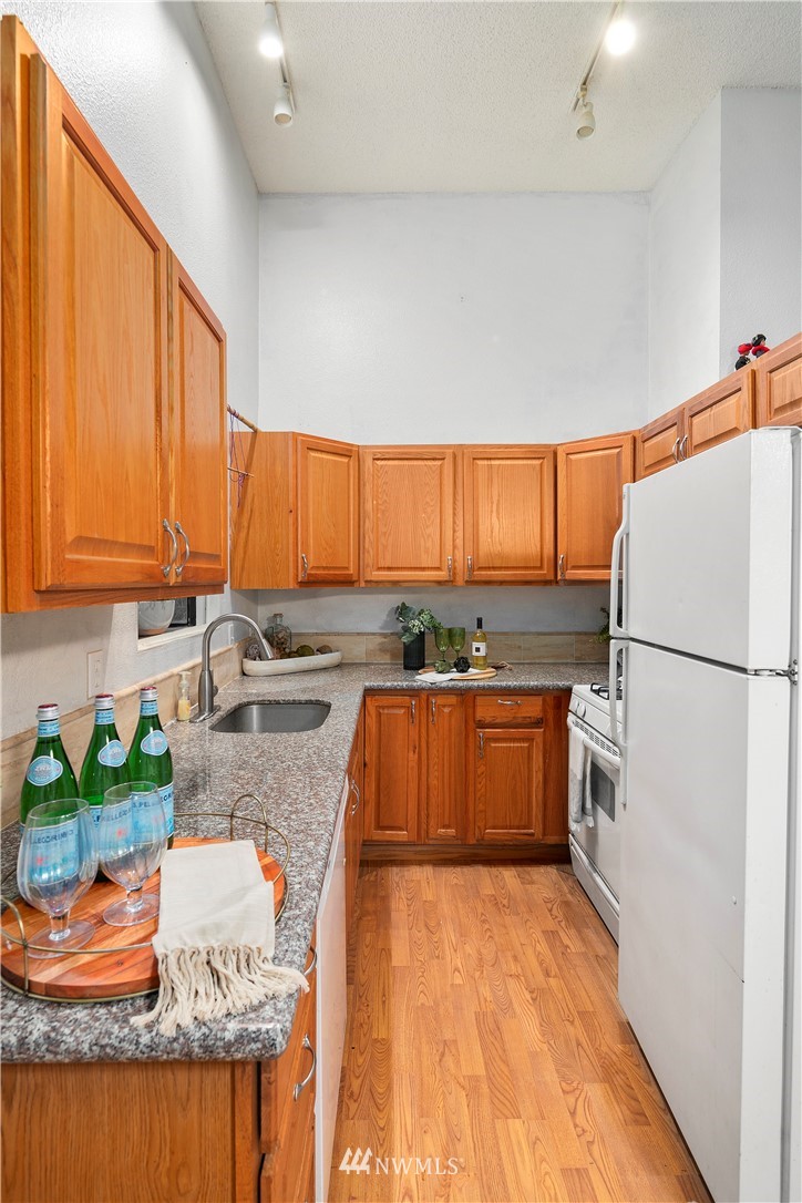 18433 126th Place Southeast Renton, WA 98058 - Photo 14 of 22 a kitchen with stainless steel appliances granite countertop a refrigerator and a stove