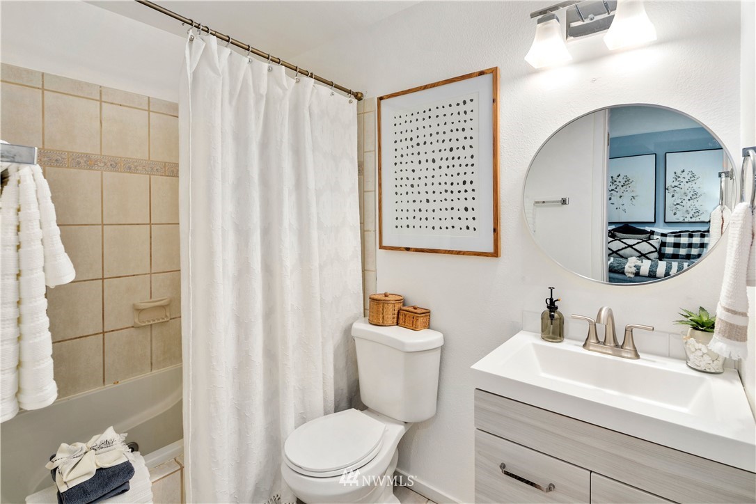 18433 126th Place Southeast Renton, WA 98058 - Photo 15 of 22 a bathroom with a sink a toilet and shower curtain