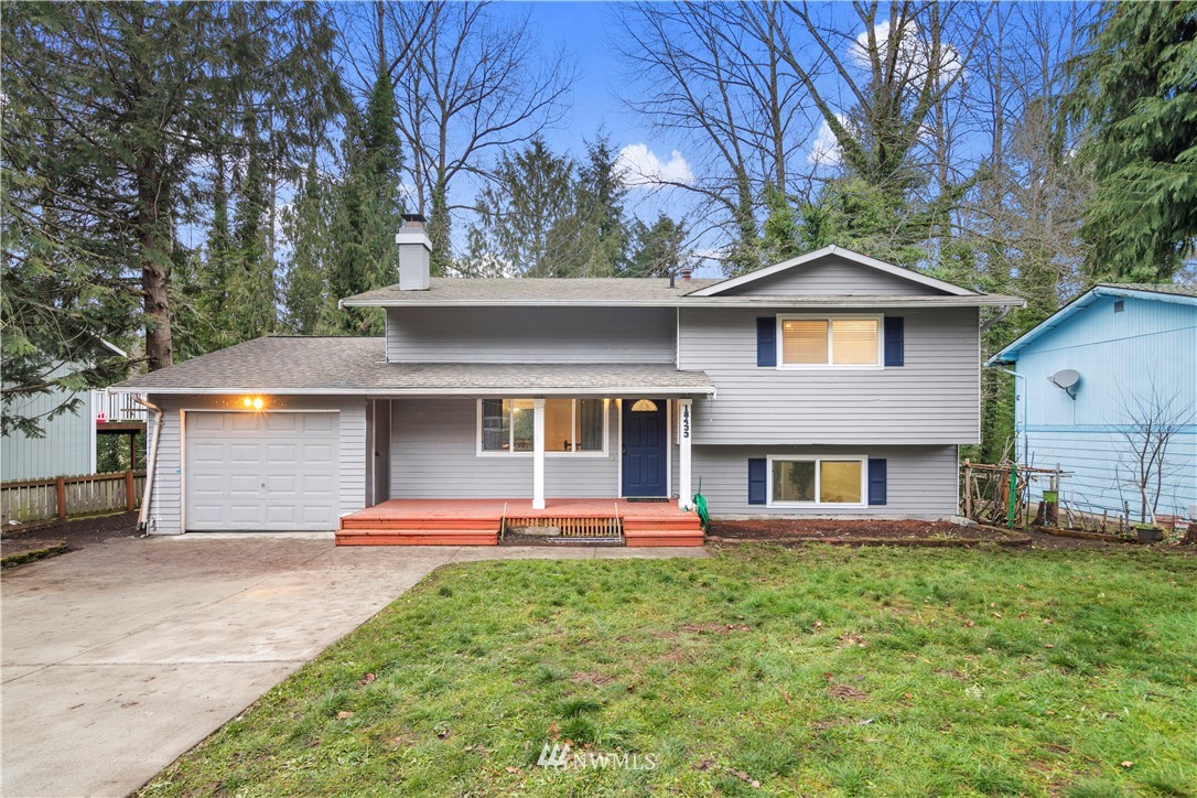 18433 126th Place Southeast Renton, WA 98058 - Photo 19 of 22 a front view of a house with a yard