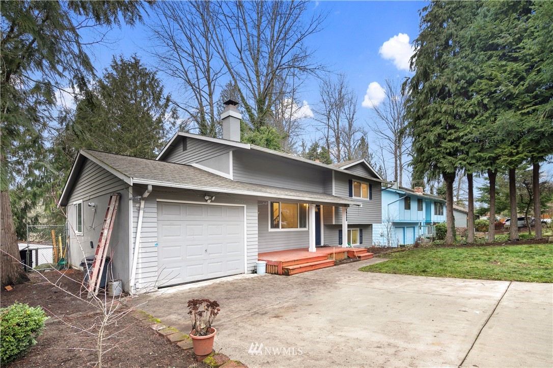 18433 126th Place Southeast Renton, WA 98058 - Photo 20 of 22 a view of a white house with large tree and yard
