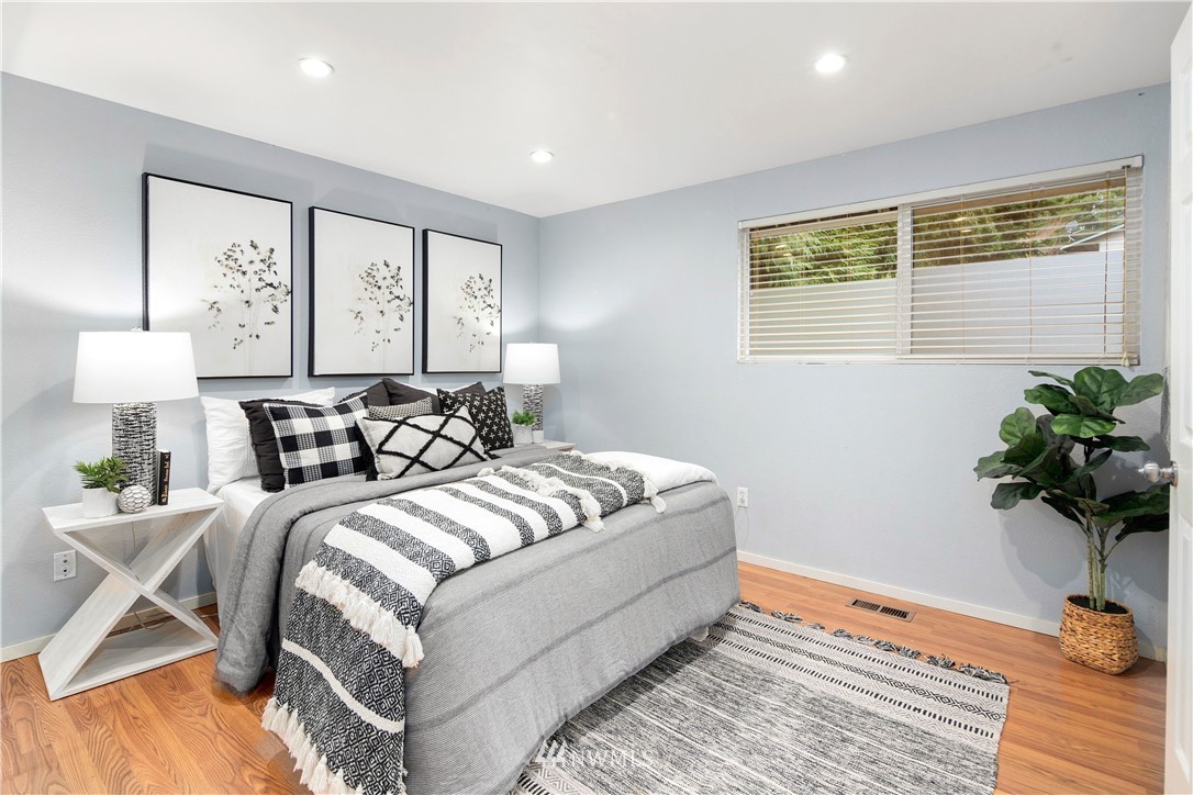 18433 126th Place Southeast Renton, WA 98058 - Photo 6 of 22 a bed room with a bed and a potted plant