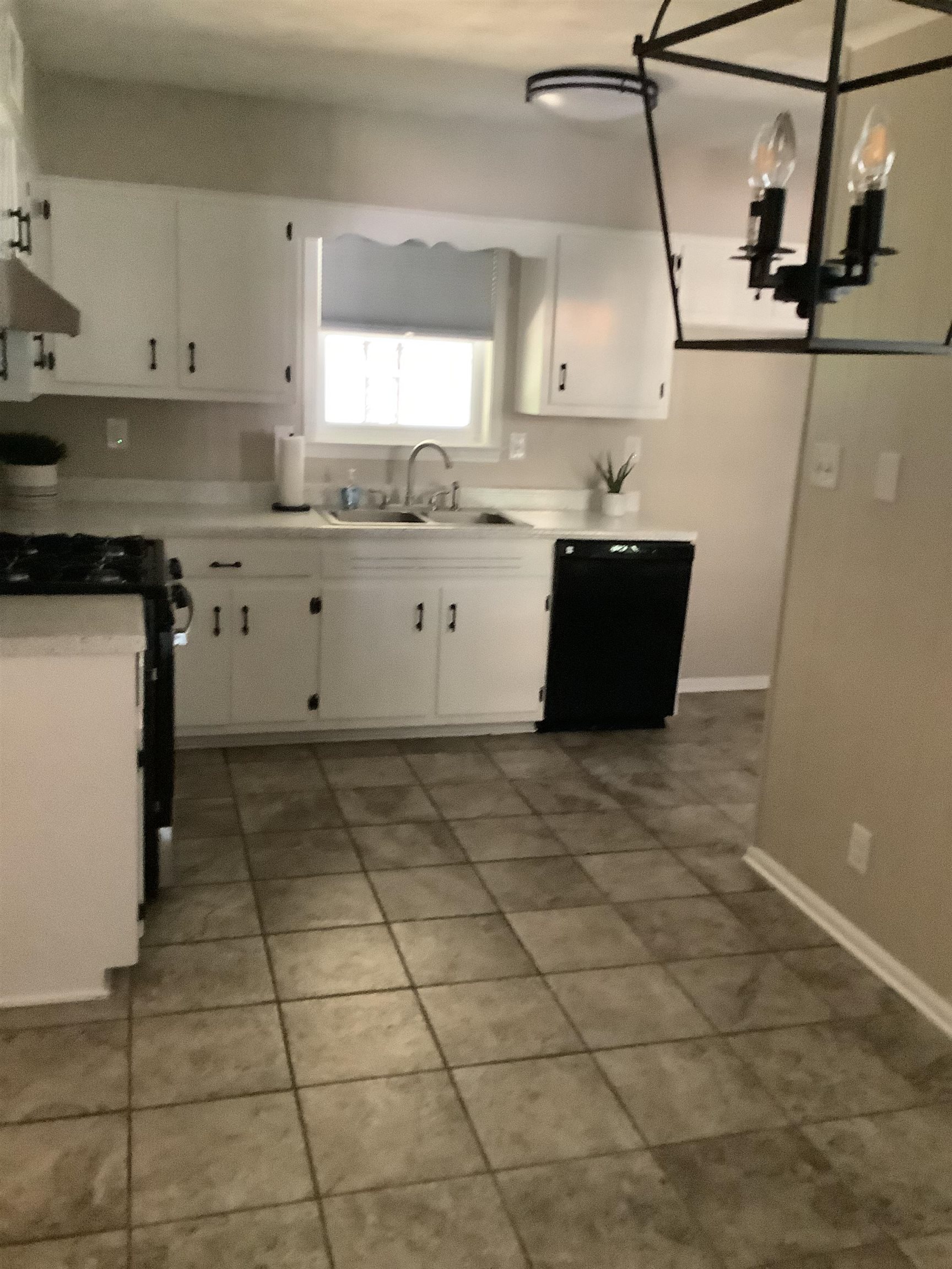 4179 Riche Road Memphis, TN 38128 - Photo 4 of 14 Kitchen with dishwasher, white cabinetry, sink, and range hood