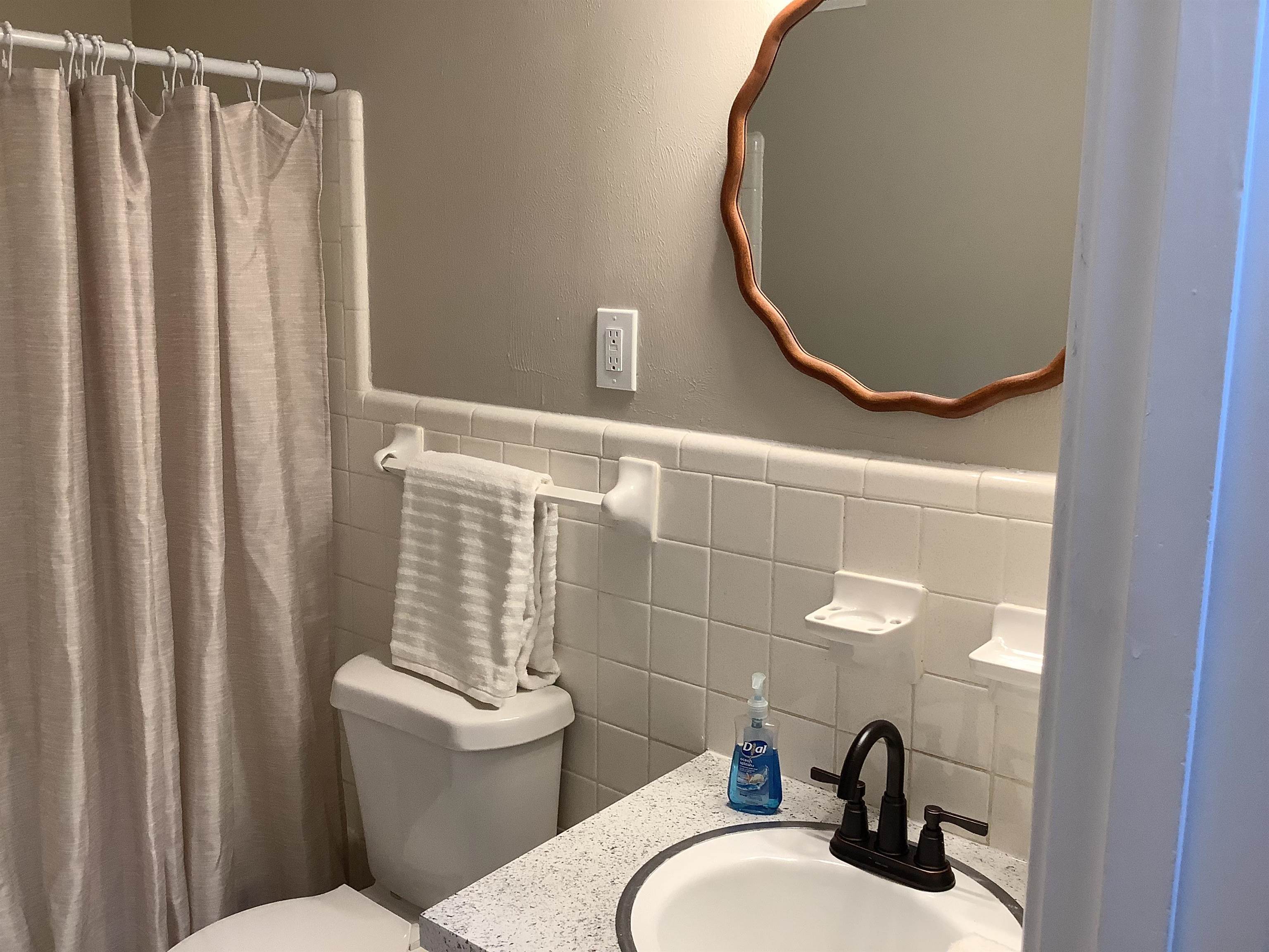4179 Riche Road Memphis, TN 38128 - Photo 8 of 14 Bathroom featuring walk in shower, vanity, tile walls, and toilet
