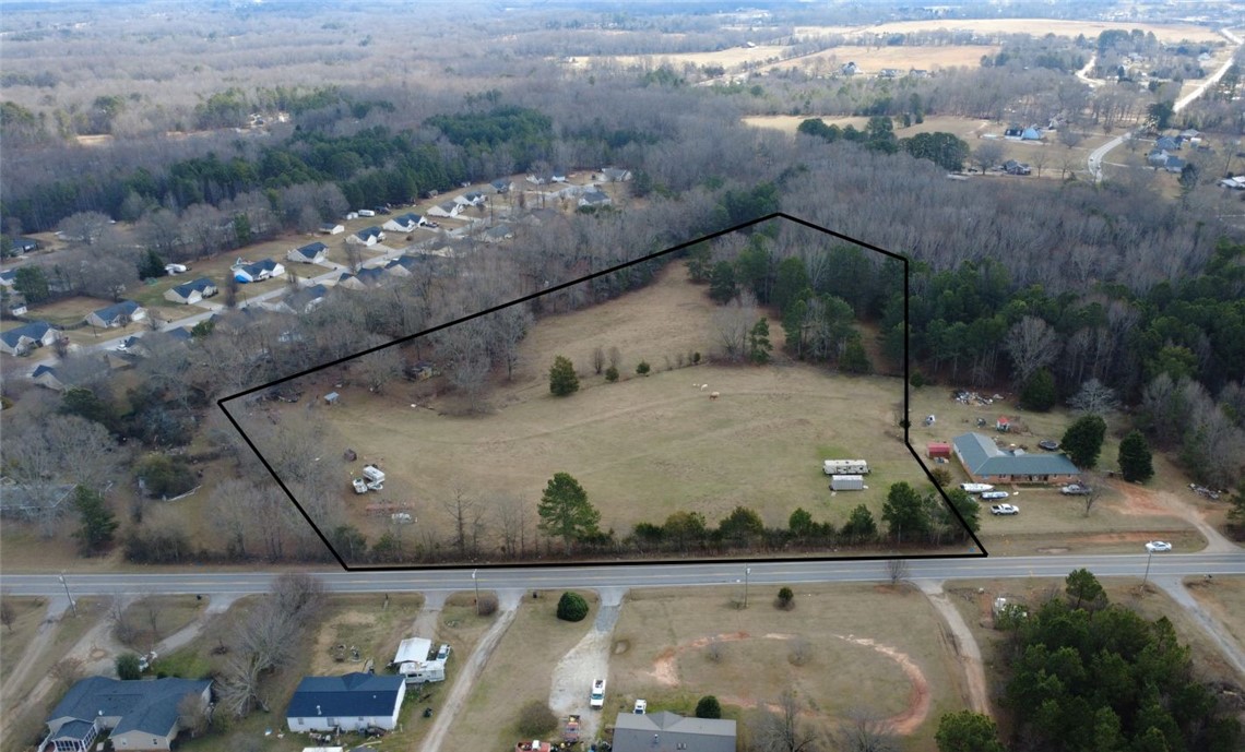 6980 Midway Road Pelzer, SC 29669 - Photo 2 of 15 This expansive lot offers ample space for new construction, bordered by mature trees and a tranquil landscape.