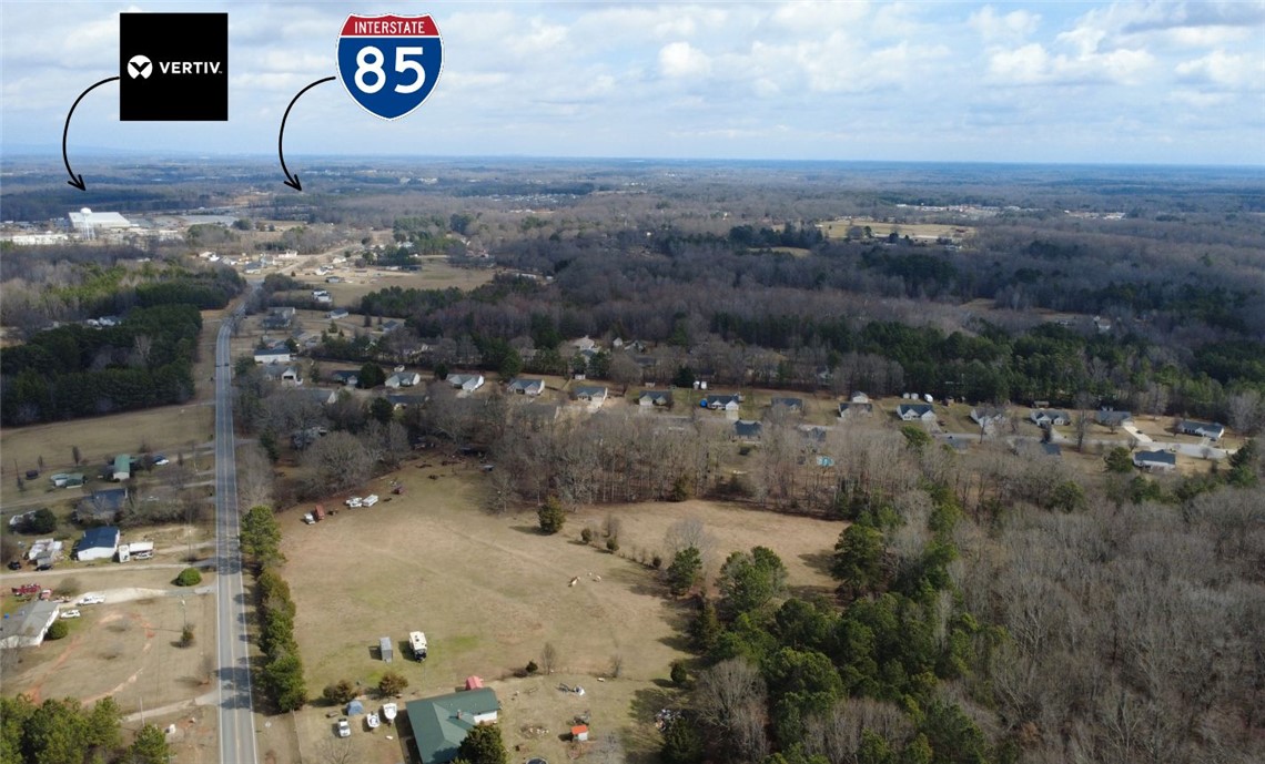 6980 Midway Road Pelzer, SC 29669 - Photo 4 of 15 This expansive aerial view showcases a vibrant community with convenient interstate access and natural surroundings.