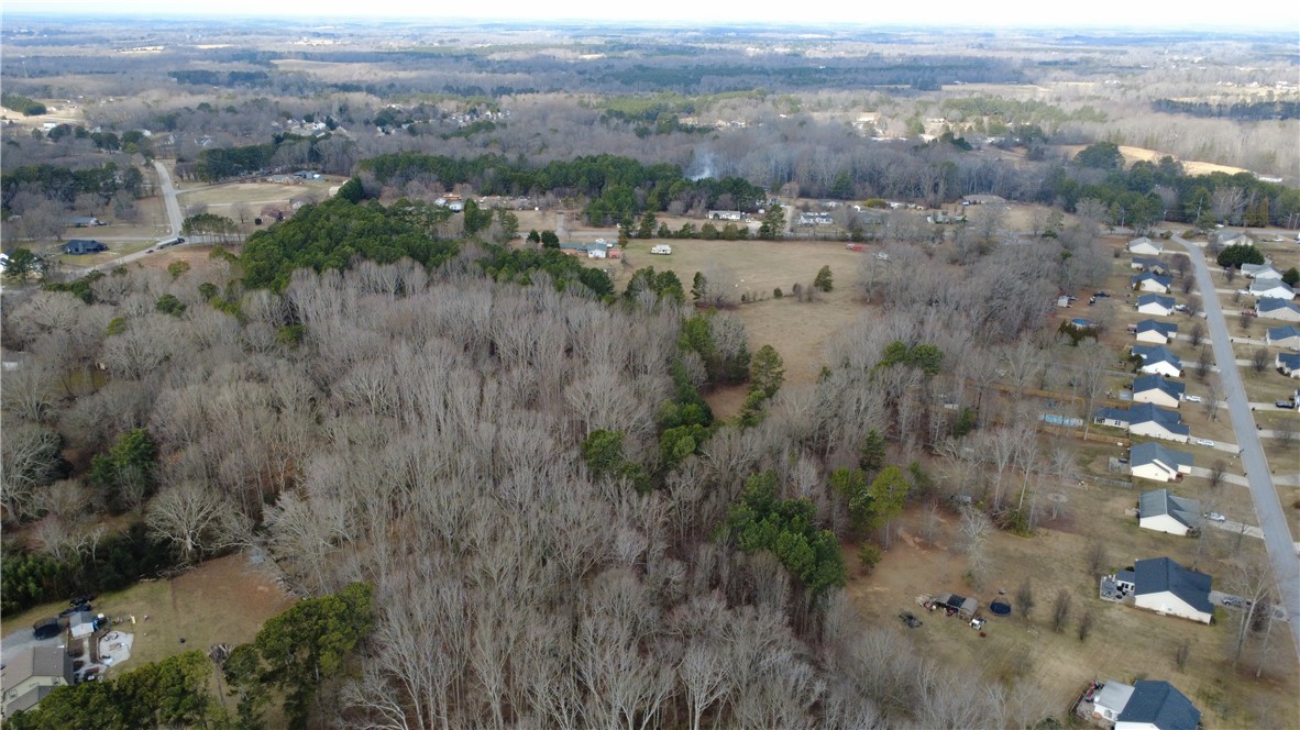 6980 Midway Road Pelzer, SC 29669 - Photo 5 of 15 This expansive aerial view showcases a vibrant community nestled amidst lush, natural surroundings.
