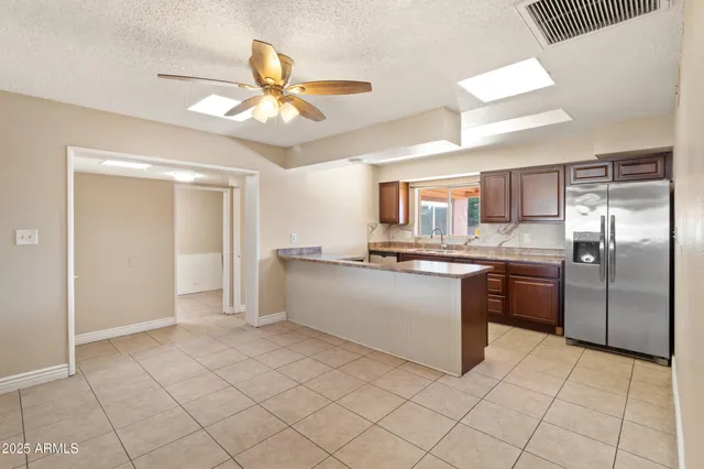 a large kitchen with a cabinets and stainless steel appliances