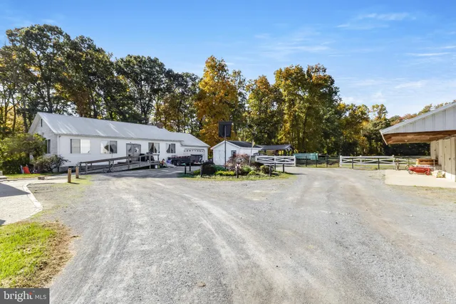 a view of a swimming pool with a patio and a yard