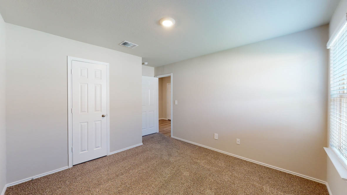509 Hector Loop Georgetown, TX 78626 - Photo 24 of 31 A well-proportioned bedroom offers carpet flooring and a window providing natural light.