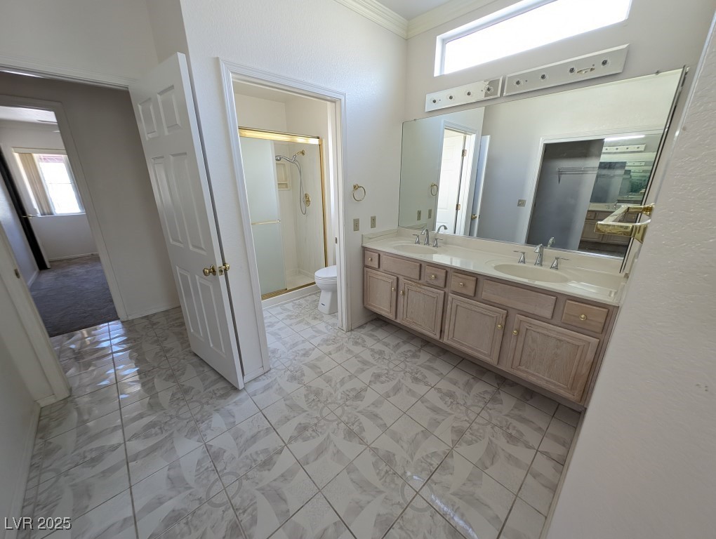 2504 Sunup Drive Las Vegas, NV 89134 - Photo 14 of 27 Full bath featuring double vanity, a stall shower, crown molding, and light marble finish floors