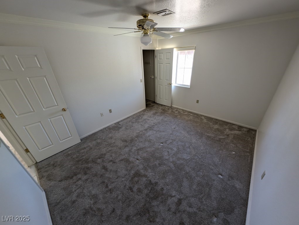 2504 Sunup Drive Las Vegas, NV 89134 - Photo 20 of 27 Unfurnished bedroom featuring ornamental molding, carpet, and ceiling fan