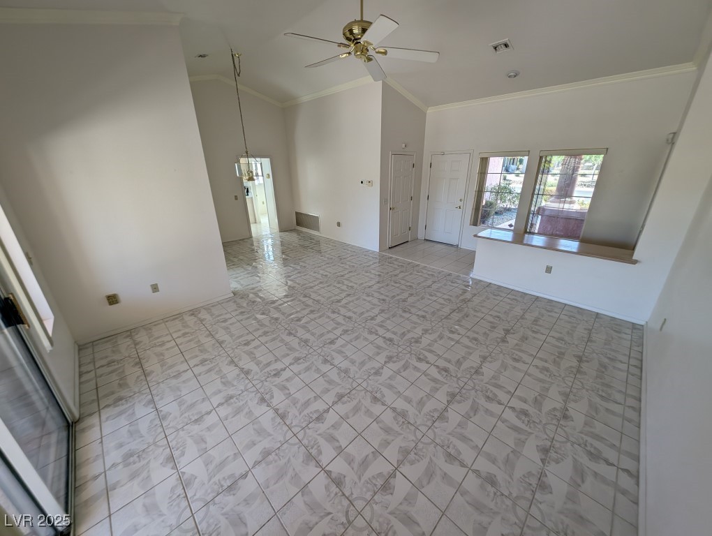 2504 Sunup Drive Las Vegas, NV 89134 - Photo 2 of 27 Unfurnished room featuring crown molding, high vaulted ceiling, light tile patterned floors, and ceiling fan