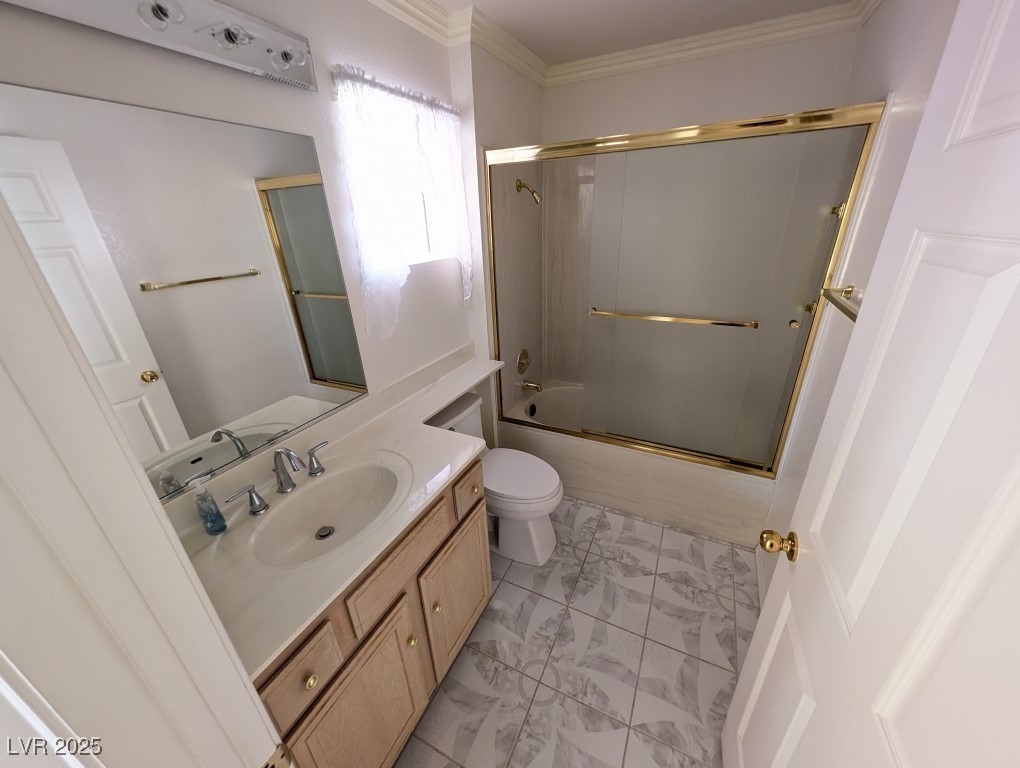 2504 Sunup Drive Las Vegas, NV 89134 - Photo 21 of 27 Full bathroom featuring vanity, bath / shower combo with glass door, and ornamental molding