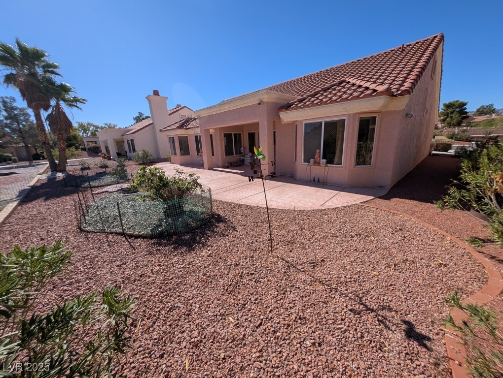 2504 Sunup Drive Las Vegas, NV 89134 - Photo 22 of 27 Back of property with a patio, stucco siding, and a tiled roof