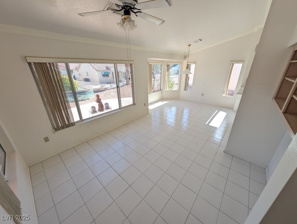 2504 Sunup Drive Las Vegas, NV 89134 - Photo 5 of 27 Unfurnished room featuring ornamental molding, light tile patterned floors, a ceiling fan, and vaulted ceiling