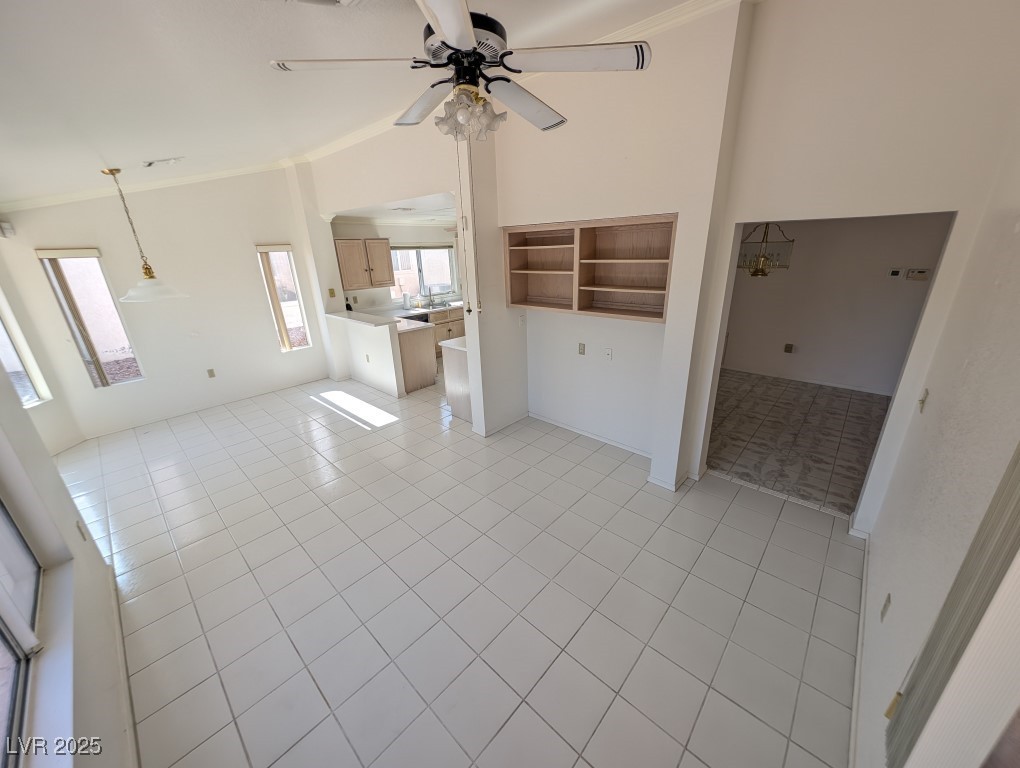 2504 Sunup Drive Las Vegas, NV 89134 - Photo 6 of 27 Unfurnished living room featuring crown molding, a ceiling fan, and light tile patterned flooring