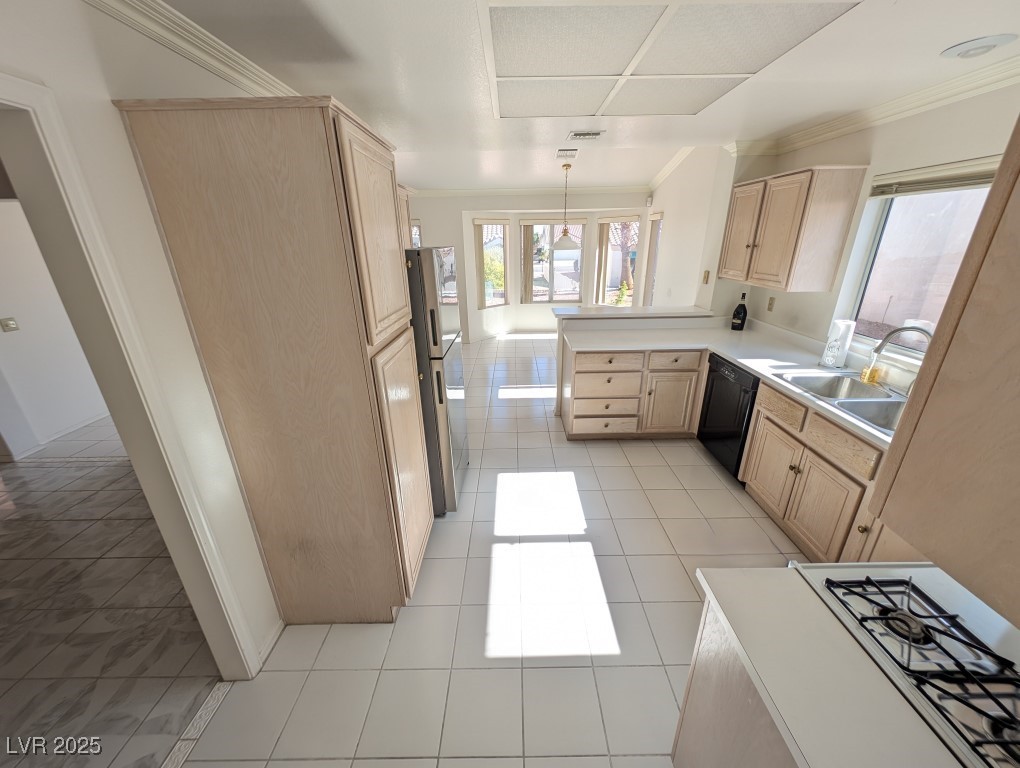 2504 Sunup Drive Las Vegas, NV 89134 - Photo 9 of 27 Kitchen with light brown cabinets, crown molding, white gas cooktop, light countertops, and light tile patterned flooring