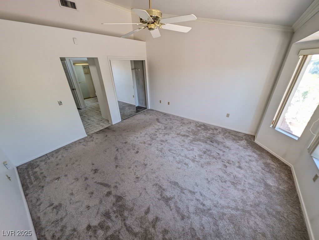 2504 Sunup Drive Las Vegas, NV 89134 - Photo 10 of 27 Unfurnished bedroom featuring carpet flooring, ceiling fan, a closet, and ornamental molding