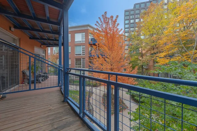 a view of balcony with wooden floor and fence