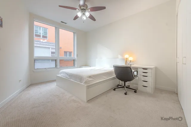 a bedroom with a bed and a night stand