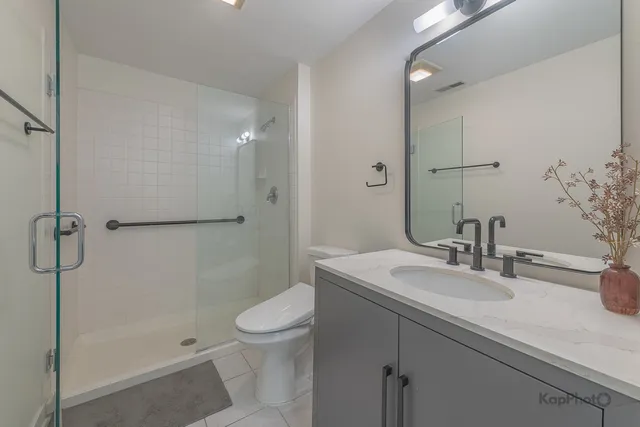 a bathroom with a toilet a sink a mirror and a bathtub