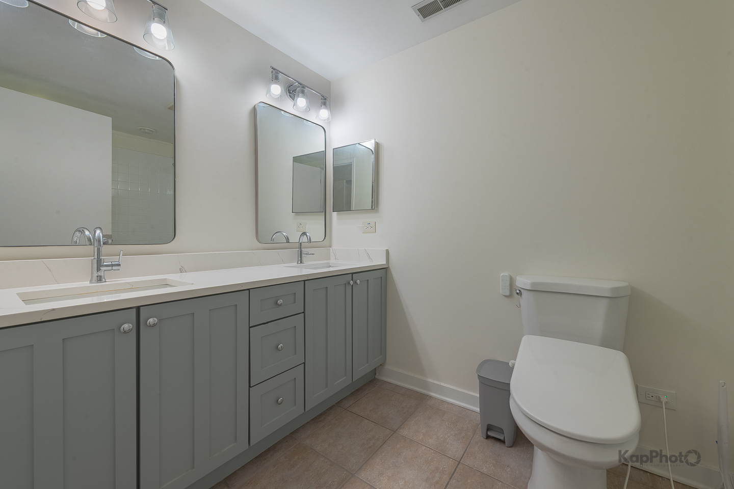 1151 West Washington Boulevard, Unit 125 Chicago, IL 60607 - Photo 22 of 28 a bathroom with a toilet sink and mirror