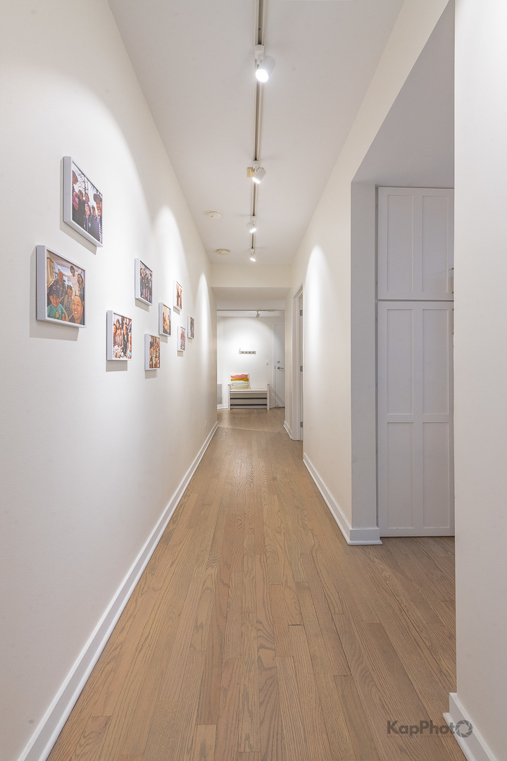 1151 West Washington Boulevard, Unit 125 Chicago, IL 60607 - Photo 3 of 28 a view of a hallway with wooden floor