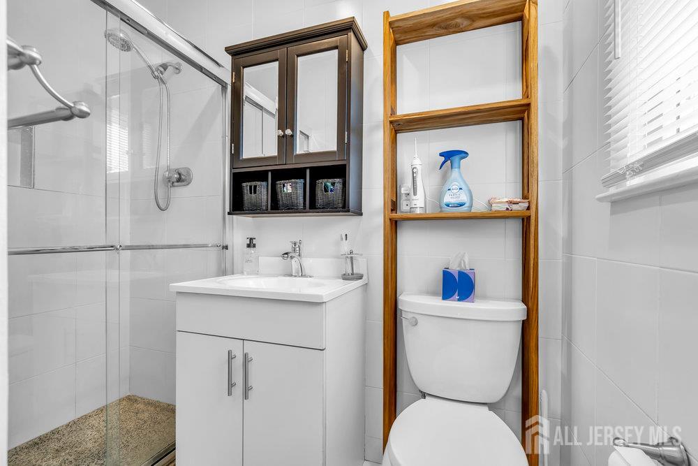 14 Academic Road East Brunswick, NJ 08816 - Photo 18 of 28 a bathroom with a toilet a sink and a window