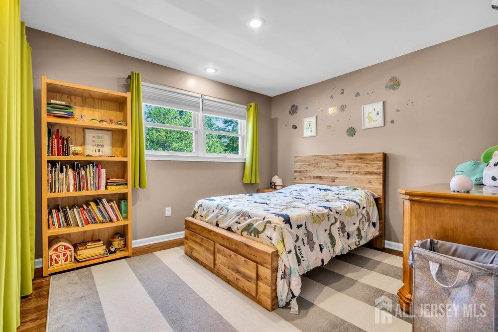 14 Academic Road East Brunswick, NJ 08816 - Photo 19 of 28 a bedroom with a bed and a book shelf