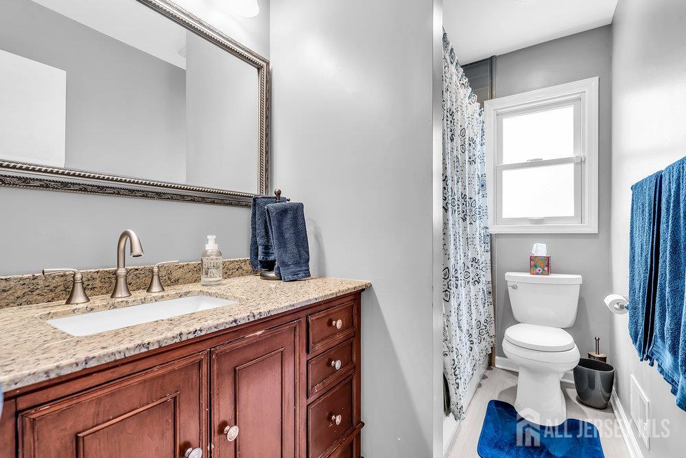 14 Academic Road East Brunswick, NJ 08816 - Photo 21 of 28 a bathroom with a granite countertop sink toilet and mirror