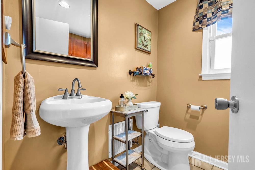 14 Academic Road East Brunswick, NJ 08816 - Photo 23 of 28 a bathroom with a toilet sink and mirror