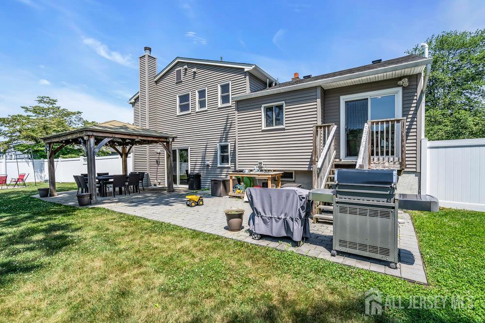 14 Academic Road East Brunswick, NJ 08816 - Photo 24 of 28 a view of a house with a backyard and chairs