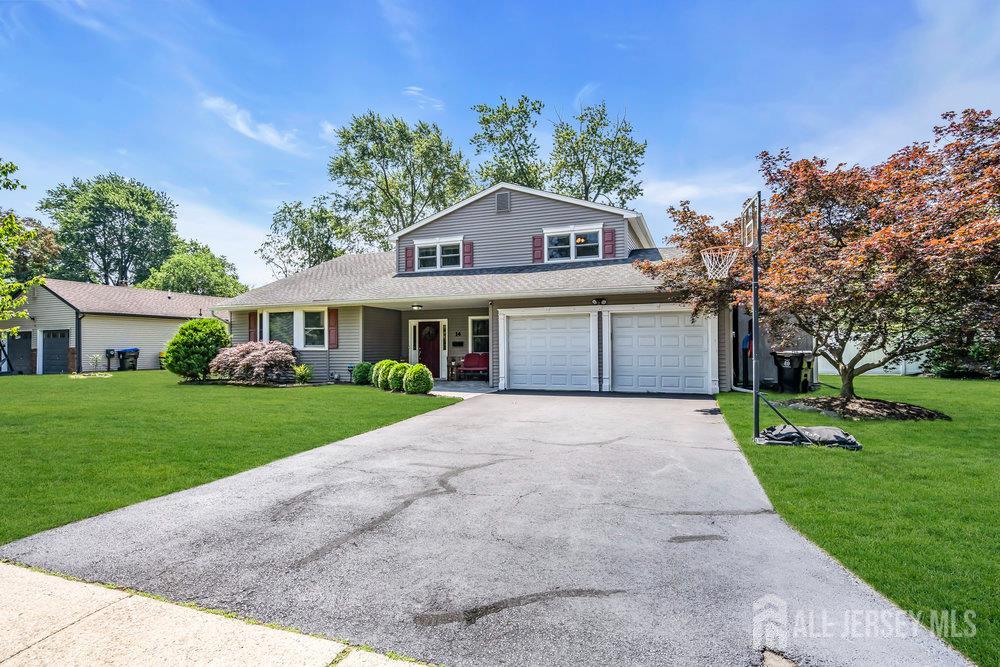 14 Academic Road East Brunswick, NJ 08816 - Photo 3 of 28 a front view of a house with a yard and garage