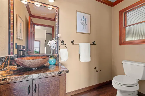 a bedroom with a bed and a lamp on dresser