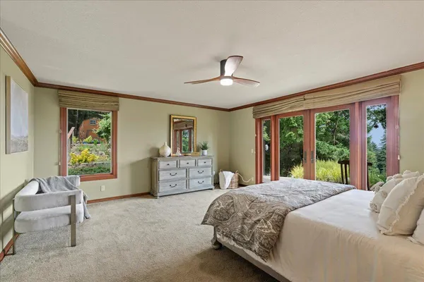 a bedroom with a large bed and a window