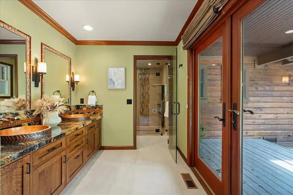 a bathroom with a sink a toilet a mirror and shower