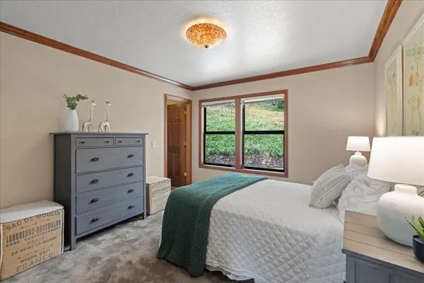 a bed room with a bed and a chandelier
