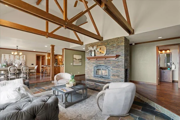 a kitchen with stainless steel appliances granite countertop a stove a sink dishwasher and a refrigerator with wooden cabinets