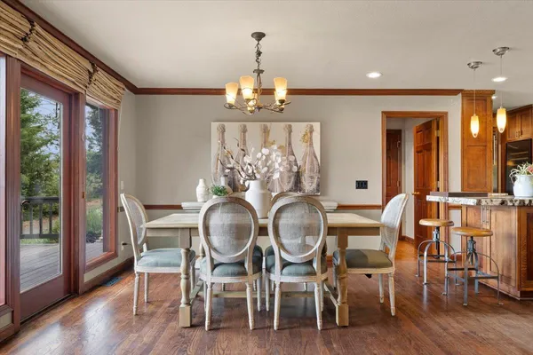 a kitchen with stainless steel appliances granite countertop a stove and a view of living room