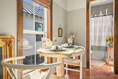 a dining room with furniture and wooden floor