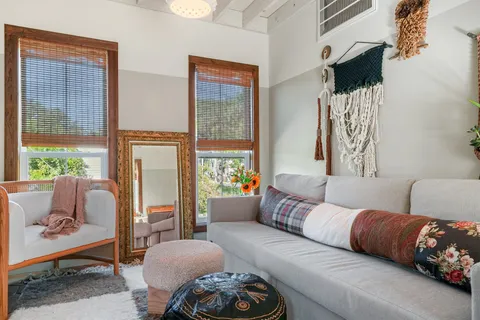 a living room with furniture fireplace and window