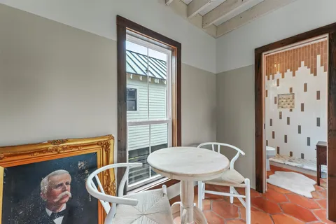 a balcony with table and chairs